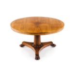 A breakfast tableSolid and veneered satinwood Round tilt top Central shaft, scalloped stand of