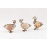 A group of three ducksSilver Moulded, engraved and chiselled resting onto egg shaped hardstone Glass