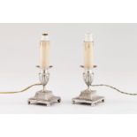 A pair of low candlesticks wired for electricityPortuguese silver Neoclassical fluted decoration