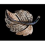 A broochGold and silver Leaf set with 98 rose cut diamonds and 24 sapphires in various cuts In the