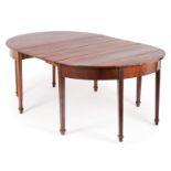 A George III style dining tableSolid and veneered Brazilian rosewood On eight feet (with two