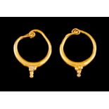 A pair of Roman earringsGold Loops of granites finials Roman Period, 2nd / 3rd millennium