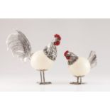A cockerel and henSilver and ostrich egg Moulded, scalloped and chiselled silver applied onto