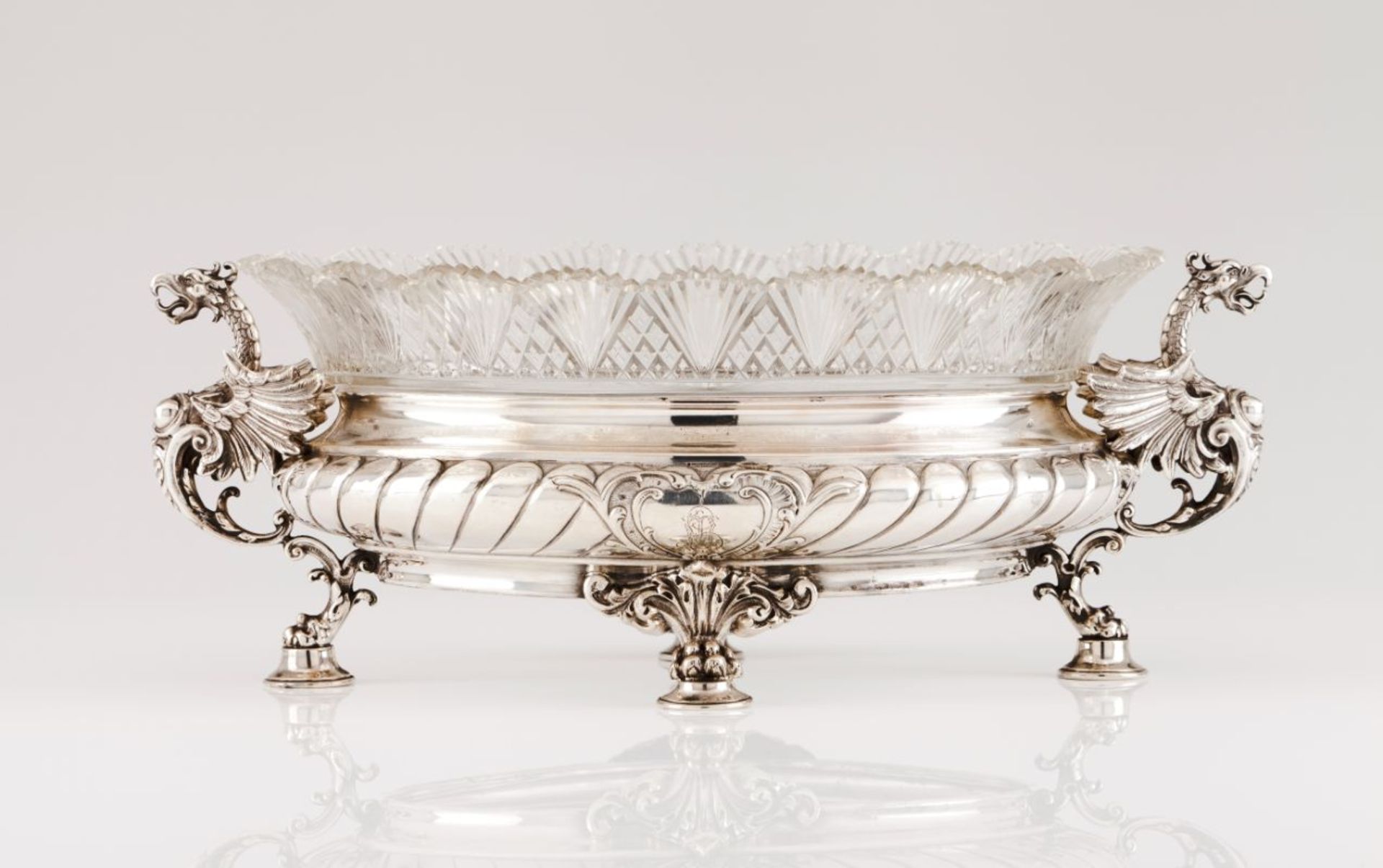 A centrepieceSilver and cut crystal Crystal bowl resting on oval, part gadrooned stand of two