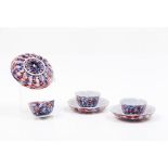 A set of three bowls and saucers