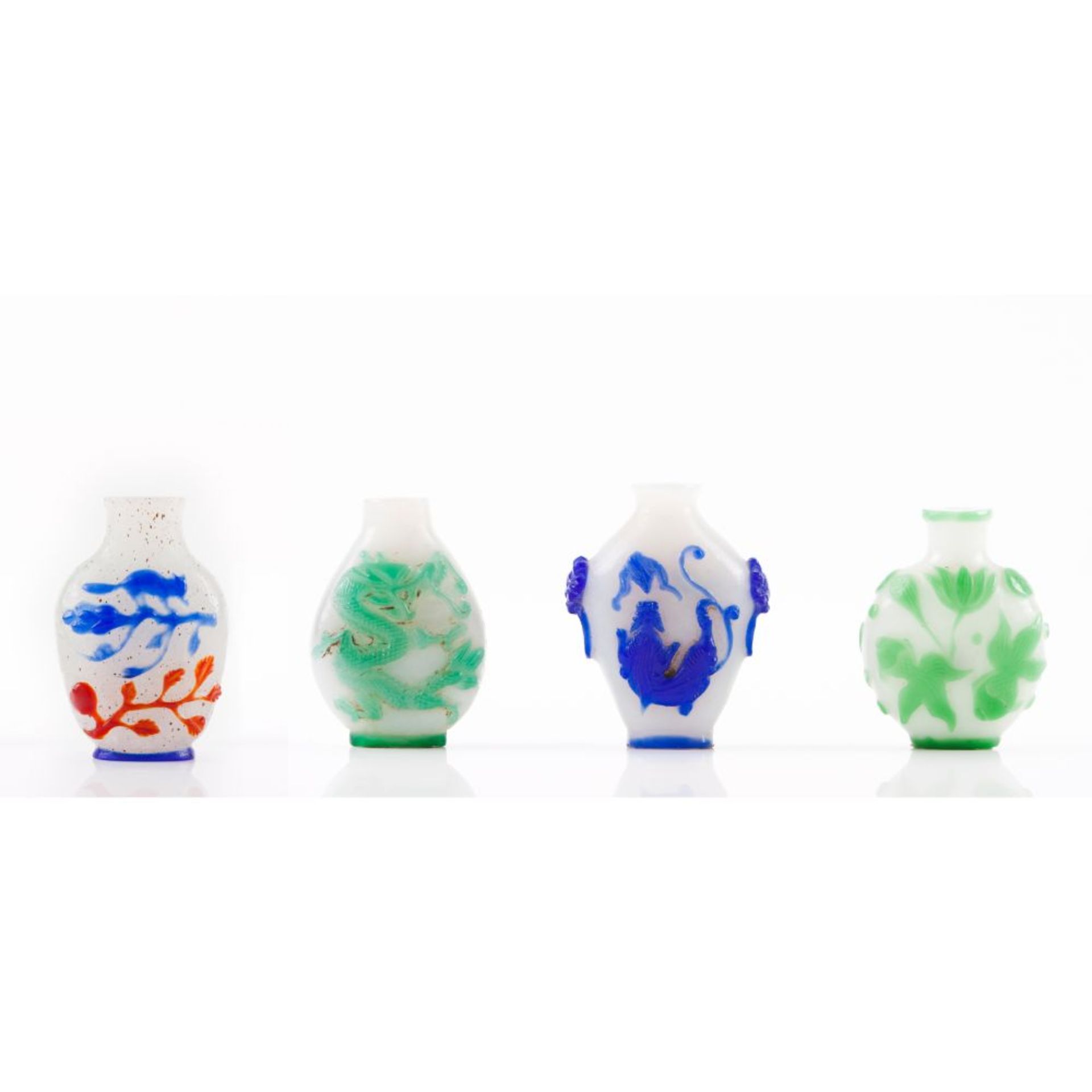 A set of four overlay glass snuff bottles