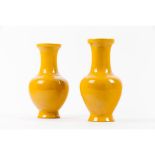 A pair of monochrome yellow baluster vases