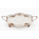 A scalloped and galleried four footed tray