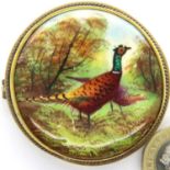 Victorian porcelain painted pheasant brooch, signature indistinct, D: 48 mm. P&P Group 1 (£14+VAT