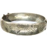 Hallmarked silver snap bangle with safety chain, Chester assay, 20g. Several dents. P&P Group 1 (£