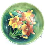 Moorcroft green ground large freesia pattern bowl with dark blue outer. Signed Walter Moorcroft