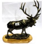 A large bronzed cast iron stag, raised on a polished wood plinth, L: 48 cm. Not available for in-