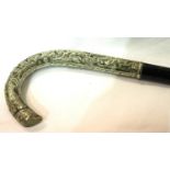 Ebonised walking stick with white metal handle featuring Oriental figures. Not available for in-