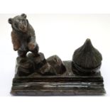 Antique carved wood Black Forest bear desk pen stand with incorporated inkwell. Bear arms has