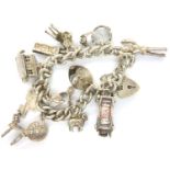 925 silver charm bracelet with ten charms, 58g. P&P Group 1 (£14+VAT for the first lot and £1+VAT