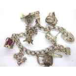 Silver charm bracelet with padlock clasp and nine charms, 46g. P&P Group 1 (£14+VAT for the first