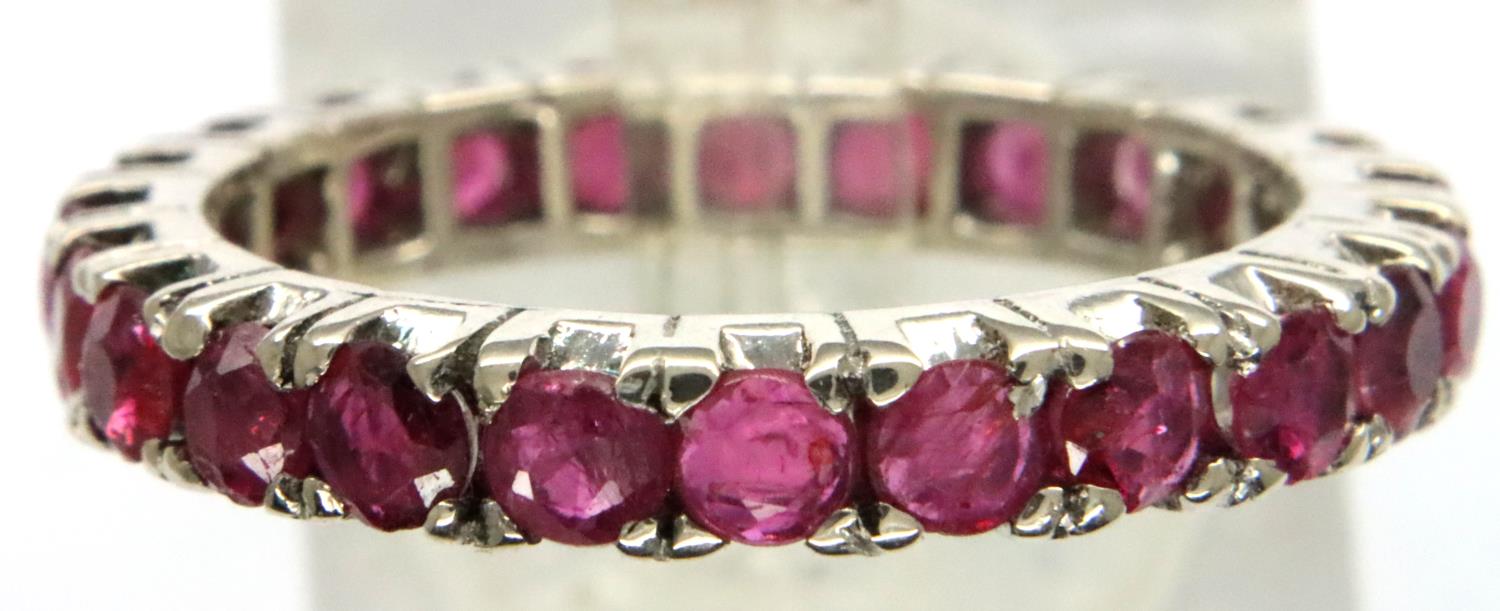 White metal and ruby full eternity ring, size O/P, 3g. P&P Group 1 (£14+VAT for the first lot and £