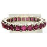 White metal and ruby full eternity ring, size O/P, 3g. P&P Group 1 (£14+VAT for the first lot and £