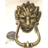 A large bronzed cast iron lion mask door knocker with fixing bolts, L: 20 cm. P&P Group 2 (£18+VAT