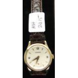 Garrard; 9ct gold mechanical wristwatch, champagne dial, seconds sub dial and brown leather strap,