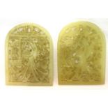A pair of Chinese pale celadon hardstone arched amulets, each with reticulated floral design