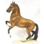 Goebel figurine of a chestnut and black coloured rearing horse, model number 309, dated 1969, H: