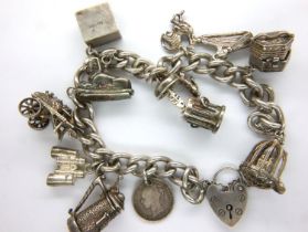 Sterling silver charm bracelet with eleven charms and safety chain, L: 16 cm, 68g. P&P Group 1 (£