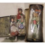 Tin containing three vintage souvenir dolls and a boxed vintage doll on a stand. Not available for