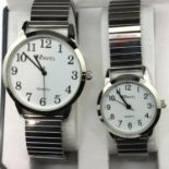 Ravel; ladies and gents matching wristwatches with black and white face, on stainless steel strap.