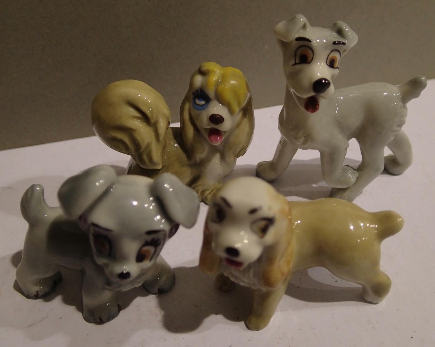 Four small Wade dog figurines to include Lady and the Tramp. P&P Group 1 (£14+VAT for the first