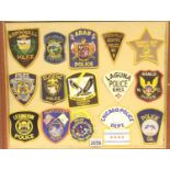 A presentation of fifteen American embroidered Police and Sheriff department cloth patches. (