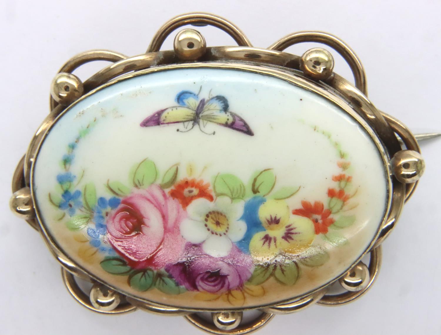 Crown Staffordshire pinchbeck framed hand painted brooch, L: 50 mm, minor discolouration verso. P&