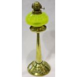 Early 20th century brass oil lamp with green glass reservoir, lacking chimney, H: 36 cm. Not