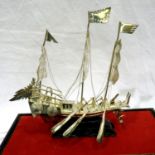 White metal Chinese war junk in glass case, 145g. P&P Group 2 (£18+VAT for the first lot and £3+