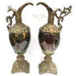 Pair of Victorian gilt metal and ceramic ewers, one damaged (holed), each H: 45 cm. P&P Group 3 (£