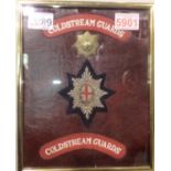 Coldstream Guards presentation, comprising brass cap badge, wired bullion and a pair of shoulder