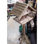 Freestanding wooden bird table, H: 160 cm. Not available for in-house P&P, contact Paul O'Hea at