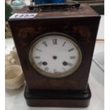 A carriage clock case and face, (no movement) with a pair of brass candlesticks. Not available for