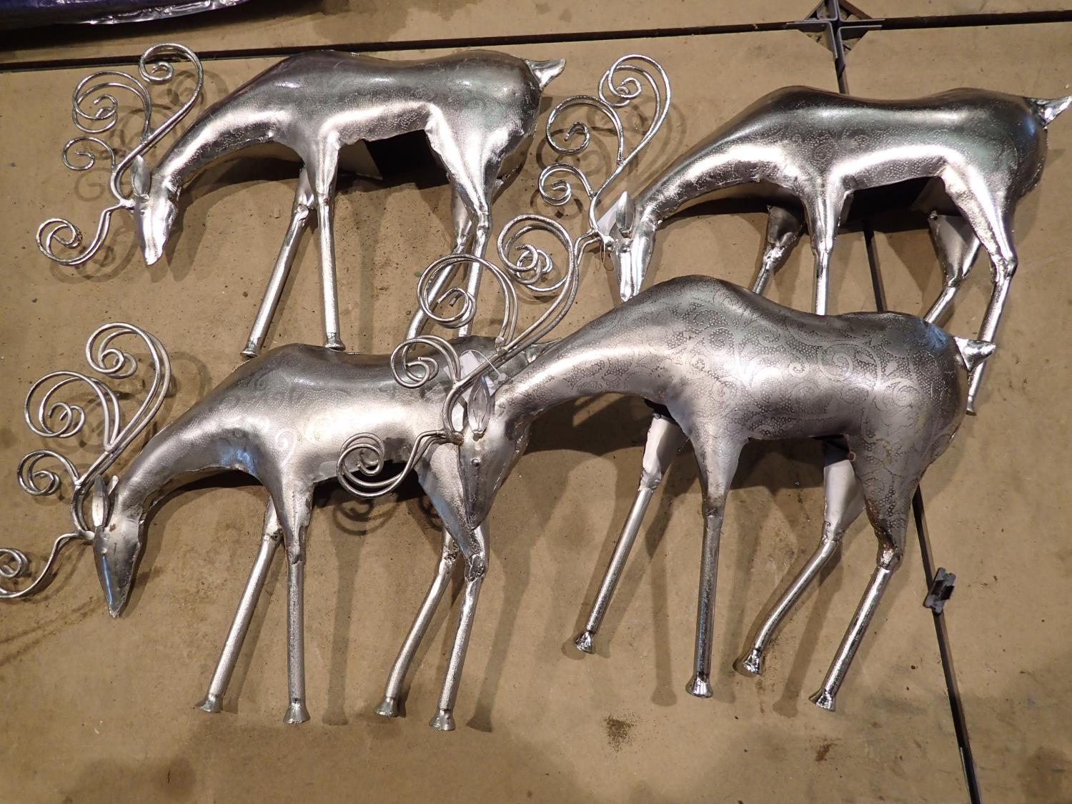 Four metal reindeer ornaments. Not available for in-house P&P, contact Paul O'Hea at Mailboxes on