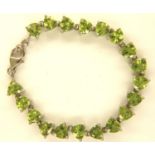 Peridot platinum overlay 925 silver bracelet, L: 19 cm. P&P Group 1 (£14+VAT for the first lot