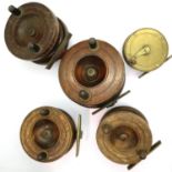 Four wood and brass vintage fishing reels and one full brass example. P&P Group 3 (£25+VAT for the