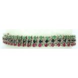 Sterling silver three strand bracelet set with rubies, sapphires and emeralds. P&P Group 1 (£14+