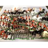 Approximately sixty cast metal Britains soldiers, mounted and foot, various regiments, in mostly