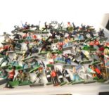 Approximately sixty plus plastic Britains soldiers, various types in mostly good condition. P&P