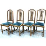 A set of four oak framed dining chairs with upholstered drop in seats. Not available for in-house