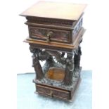 An unusual 19th century heavily carved two drawer lamp table, with supports in the form of four