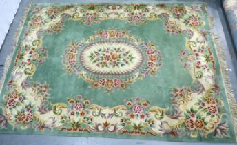 Kayam Carpets (London and Manchester) a large Chinese floor rug, green ground with floral border,