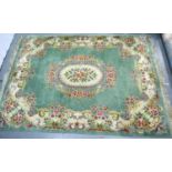 Kayam Carpets (London and Manchester) a large Chinese floor rug, green ground with floral border,