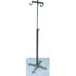 An Edwardian gentlemans height adjusting apparel stand with two hooks, raised on a cast iron