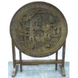 An early 20th century Chinese camphor carved table with circular top and folding frame, D: 60 cm, H: